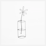 A flower in an iron wire vase