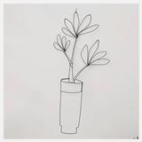 A flower in an iron wire vase