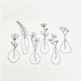 A flower in an iron wire vase